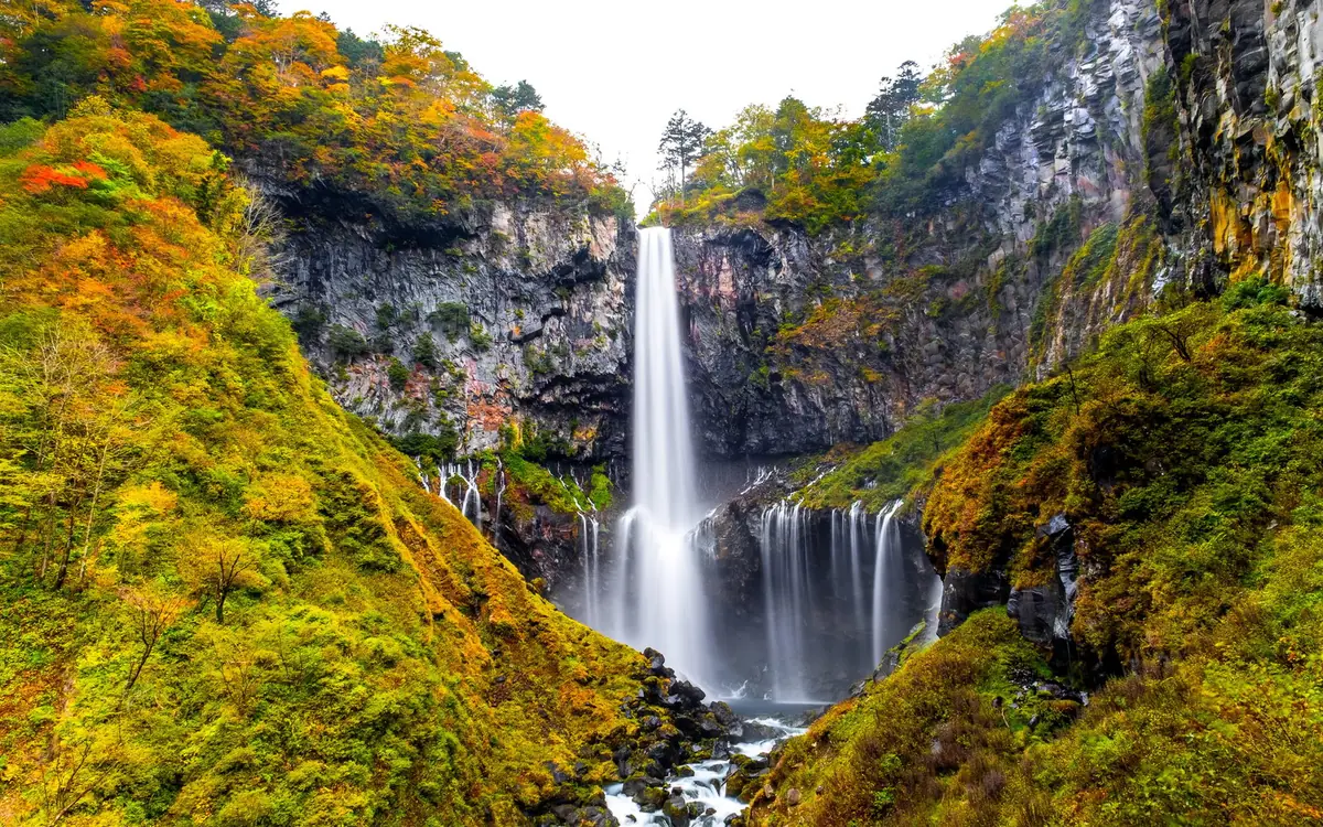 Kegon Falls dropping ninety-seven metres beside autumn forest